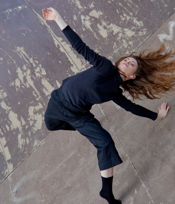 Woman performing a fluid cardio movement in a calm, focused state.